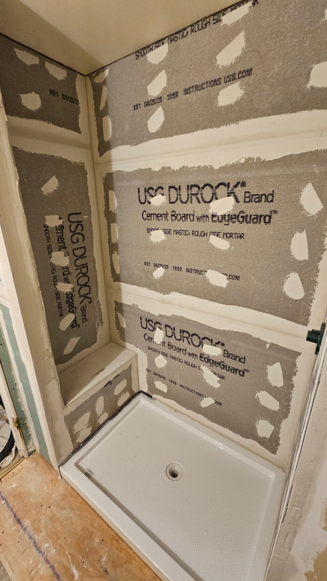 Shower walls prepared with cement board and taped seams before tile